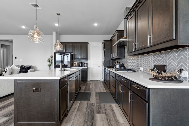 1305 Redbrick Ln, Northlake, TX 76247 - kitchen featuring dark brown cabinetry, dark wood-style floors, stainless steel appliances, light countertops, and decorative backsplash
