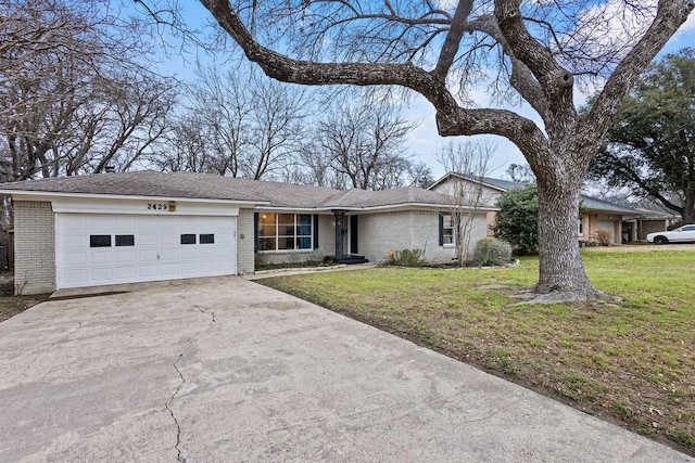 single story home with an attached garage, a front lawn, concrete driveway, and brick siding