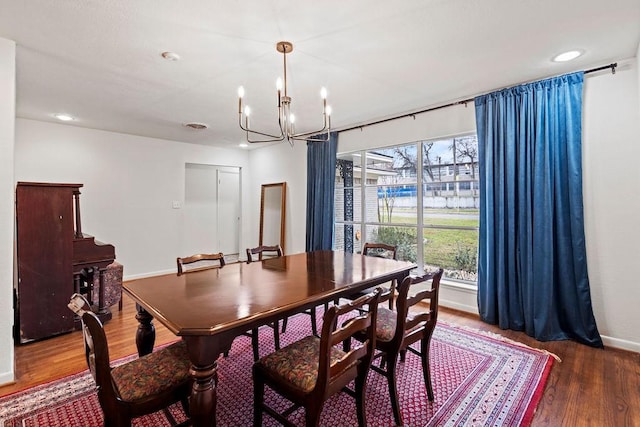 dining room with baseboards, recessed lighting, dark wood finished floors, and a notable chandelier