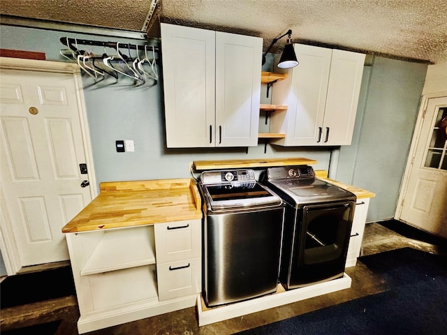 clothes washing area featuring cabinet space and separate washer and dryer