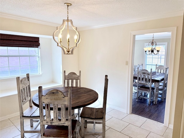 dining room with crown molding, a notable chandelier, and light tile patterned floors