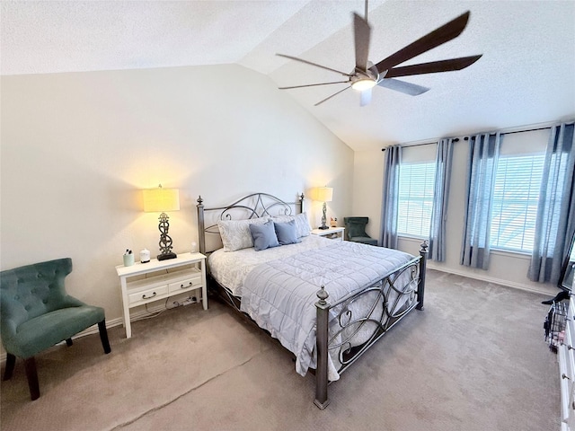 bedroom with ceiling fan, a textured ceiling, carpet flooring, baseboards, and vaulted ceiling