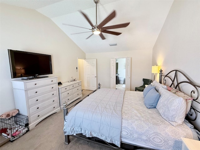 bedroom with lofted ceiling, visible vents, a ceiling fan, light carpet, and connected bathroom