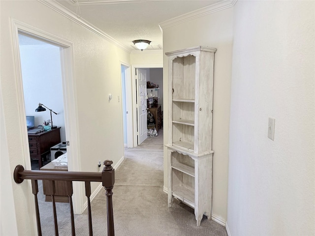 corridor with light carpet, attic access, baseboards, and crown molding