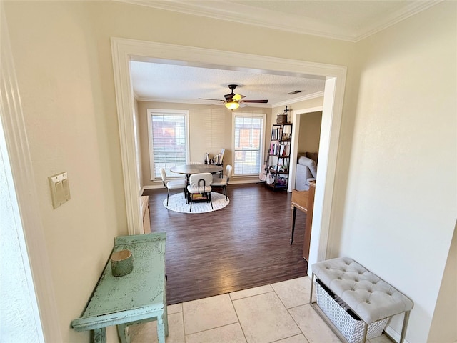 hall featuring crown molding and tile patterned floors