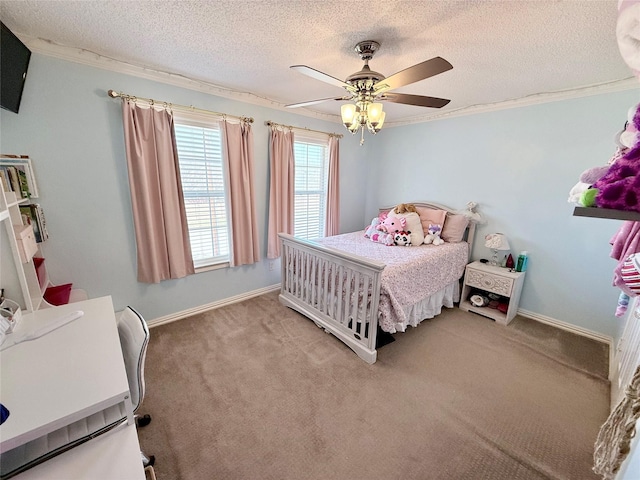 carpeted bedroom featuring a ceiling fan, crown molding, a textured ceiling, and baseboards