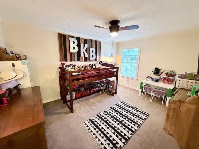 carpeted bedroom featuring ceiling fan, crown molding, baseboards, and a textured ceiling