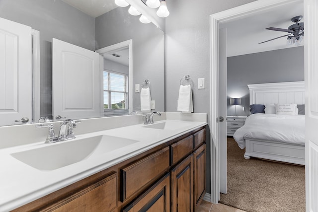 ensuite bathroom featuring double vanity, a sink, ensuite bath, and ceiling fan