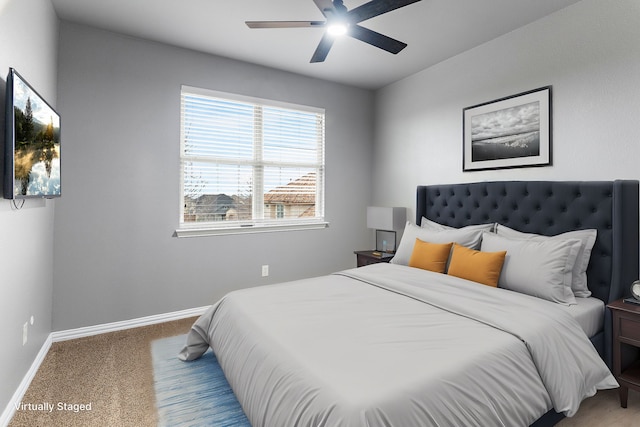 bedroom featuring light carpet, a ceiling fan, and baseboards