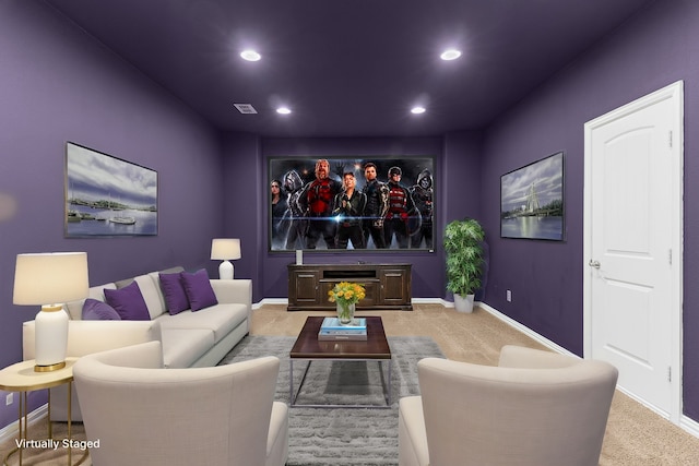 home theater featuring baseboards, carpet, a glass covered fireplace, and recessed lighting