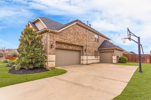 view of front of property featuring a garage, brick siding, fence, driveway, and a front lawn