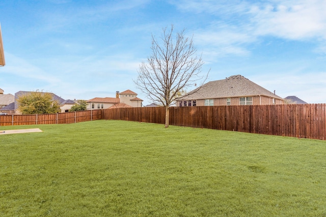 view of yard with a fenced backyard