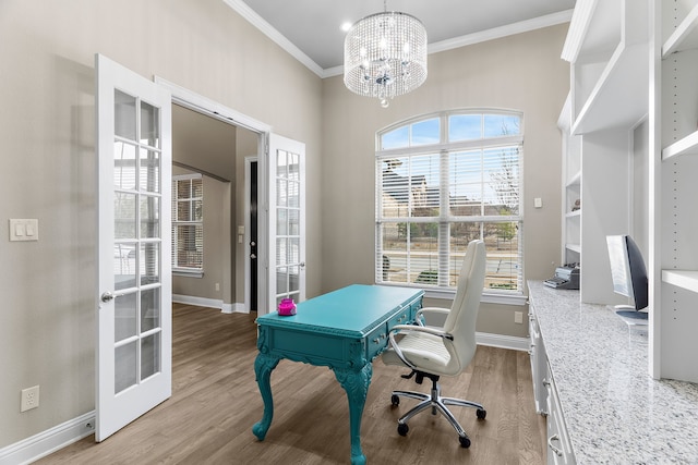 home office with baseboards, a notable chandelier, wood finished floors, and crown molding