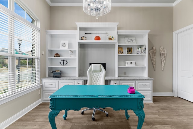 office featuring light wood-style floors, baseboards, ornamental molding, and a chandelier