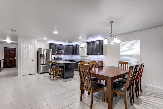 dining room featuring baseboards, visible vents, light tile patterned flooring, a notable chandelier, and recessed lighting