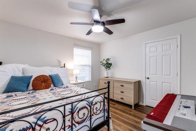 bedroom featuring a ceiling fan and dark wood finished floors