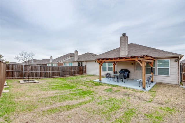 exterior space featuring a yard, a chimney, and a fenced backyard