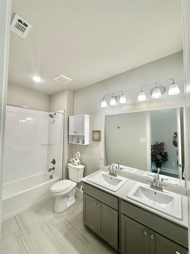 bathroom with double vanity, visible vents, a sink, and shower / bathtub combination