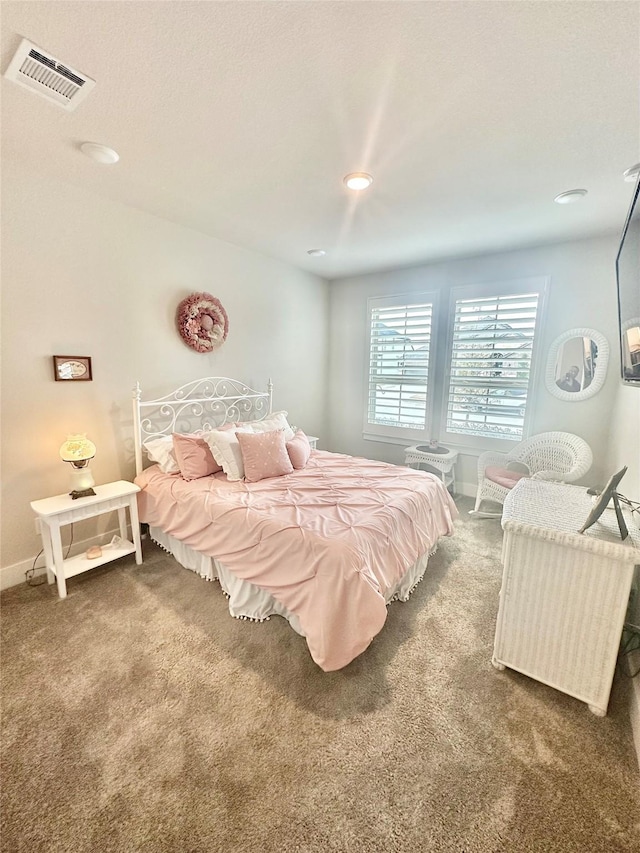 bedroom featuring baseboards, visible vents, and dark colored carpet