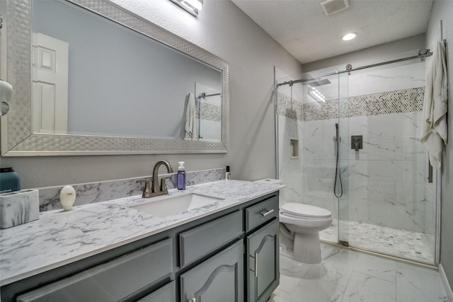 bathroom with marble finish floor, a marble finish shower, visible vents, vanity, and a textured ceiling