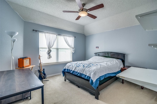 carpeted bedroom featuring lofted ceiling, ceiling fan, a textured ceiling, and baseboards