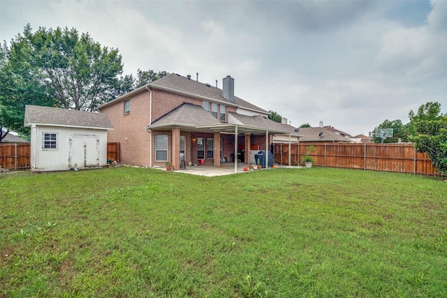 rear view of property featuring an outbuilding, a chimney, a storage shed, a patio area, and a fenced backyard