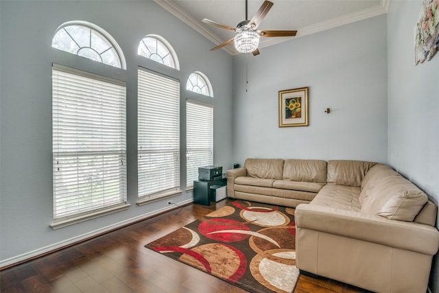 living area with dark wood-style floors, ceiling fan, vaulted ceiling, and crown molding