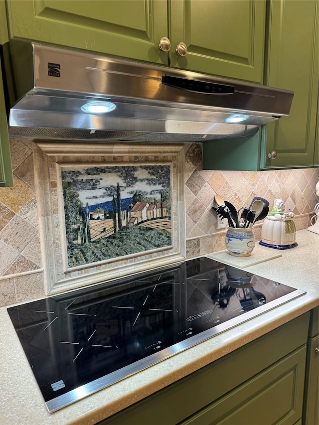 kitchen with black electric stovetop, extractor fan, and light countertops