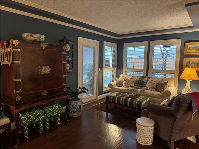 living area with a textured ceiling, ornamental molding, and wood finished floors