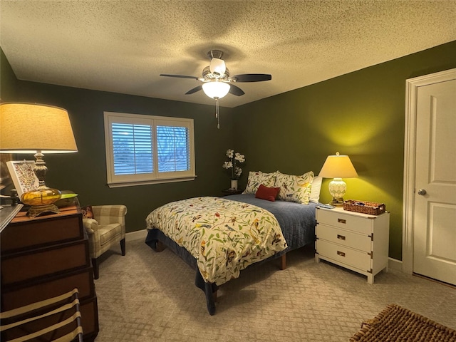 bedroom featuring light colored carpet, ceiling fan, a textured ceiling, and baseboards