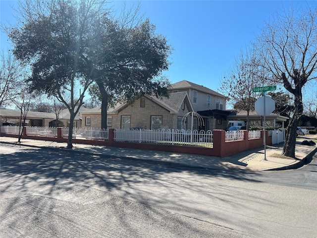 view of front of home with a fenced front yard and a residential view