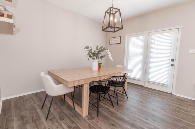 dining area featuring dark wood finished floors and baseboards