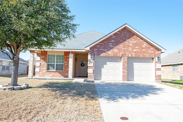 ranch-style house with a shingled roof, concrete driveway, brick siding, and an attached garage