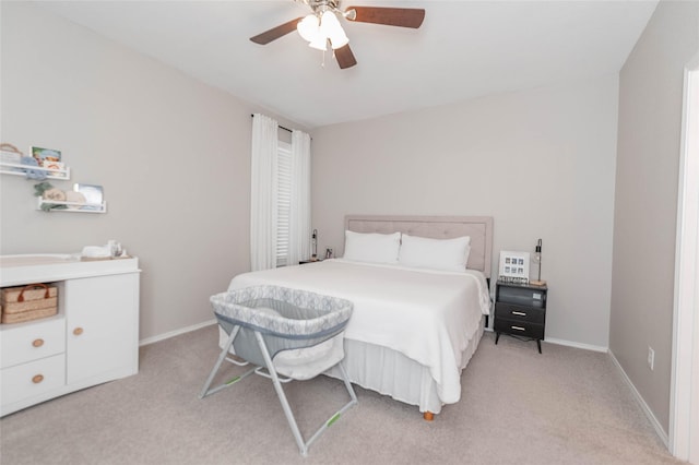 bedroom with baseboards, a ceiling fan, and light colored carpet