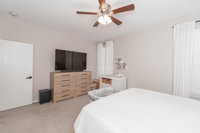 bedroom featuring a ceiling fan and light colored carpet