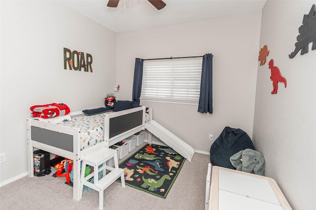 carpeted bedroom with ceiling fan and baseboards