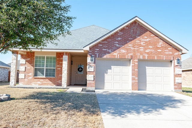 ranch-style house featuring brick siding, a shingled roof, a front yard, a garage, and driveway