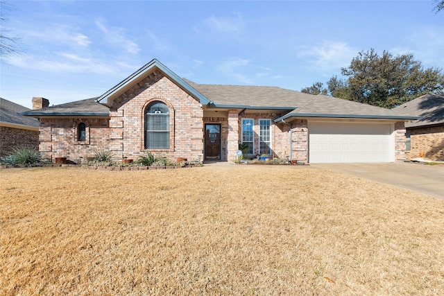 single story home featuring a garage, brick siding, a shingled roof, concrete driveway, and a front lawn