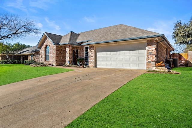 ranch-style home featuring a garage, fence, cooling unit, a front lawn, and brick siding