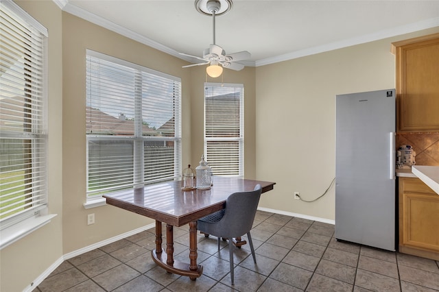 dining area featuring baseboards, ornamental molding, ceiling fan, and tile patterned floors