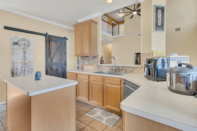 kitchen featuring a barn door, light brown cabinets, a sink, visible vents, and light countertops