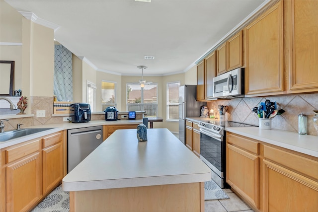 kitchen with a kitchen island, appliances with stainless steel finishes, and light countertops