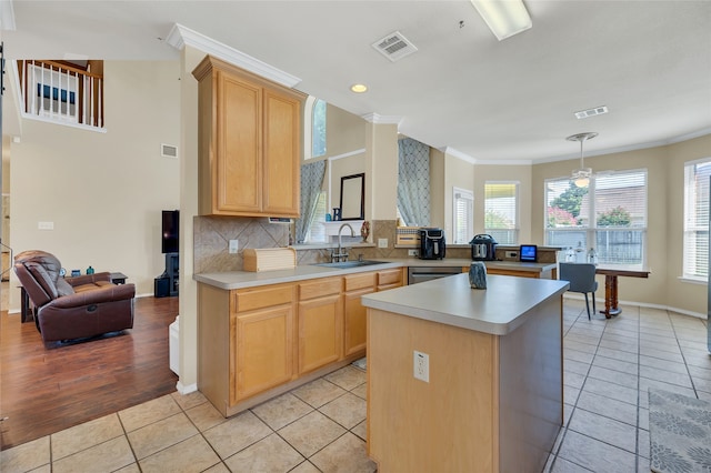 kitchen featuring light countertops, a sink, visible vents, and light brown cabinets