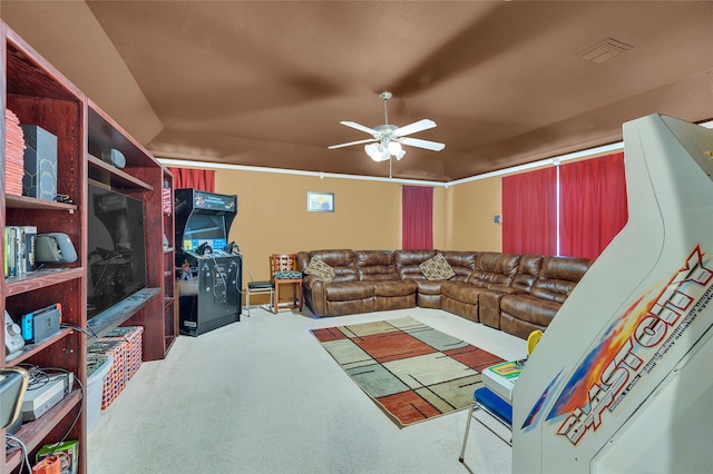 living area featuring carpet flooring, visible vents, and a ceiling fan