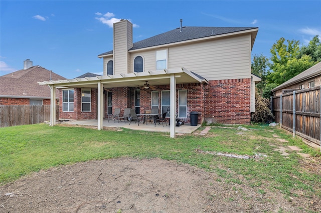 rear view of property featuring a fenced backyard, ceiling fan, a patio, and brick siding