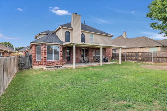 rear view of house with brick siding, a lawn, a patio area, and a fenced backyard