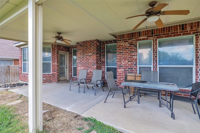 view of patio / terrace featuring fence, outdoor dining area, and a ceiling fan