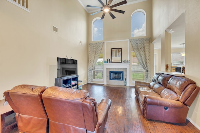 living area featuring hardwood / wood-style floors, plenty of natural light, visible vents, and a ceiling fan