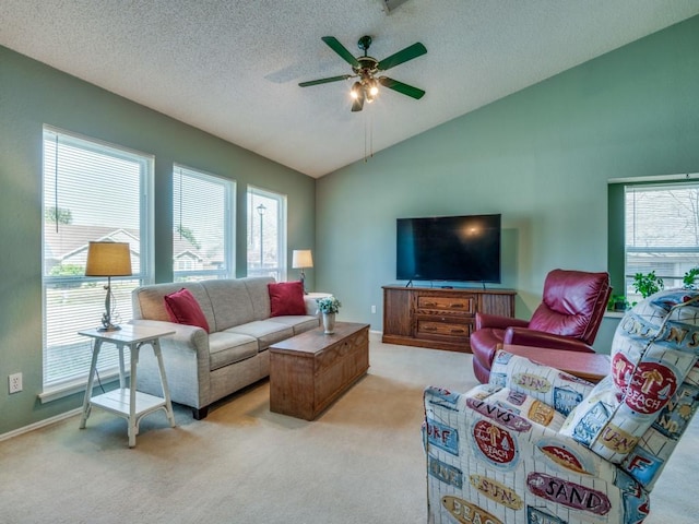 living room featuring a textured ceiling, light carpet, a ceiling fan, baseboards, and vaulted ceiling