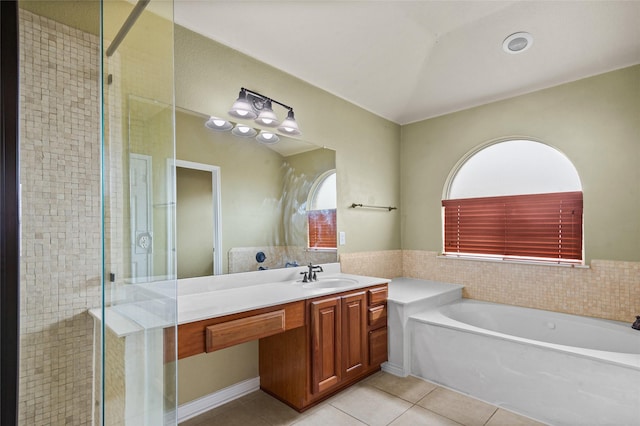 full bathroom with a shower stall, a garden tub, vanity, and tile patterned floors